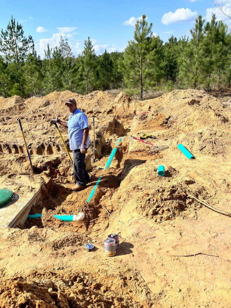 The best plumbing services in Mobile. All Clear employee standing at a work site