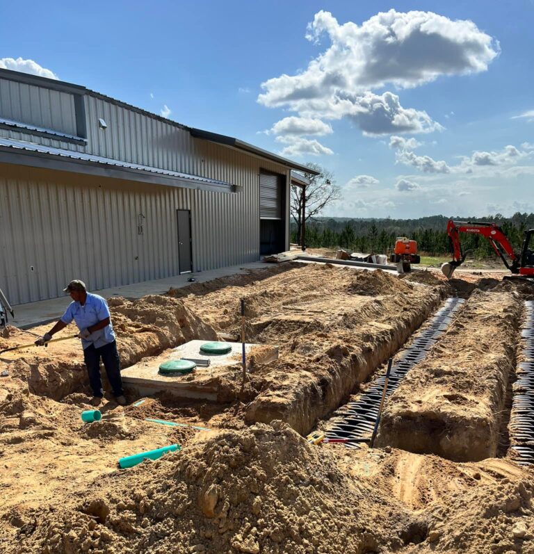 Man laying new plumbing pipes in the ground. Water line installation in Prichard