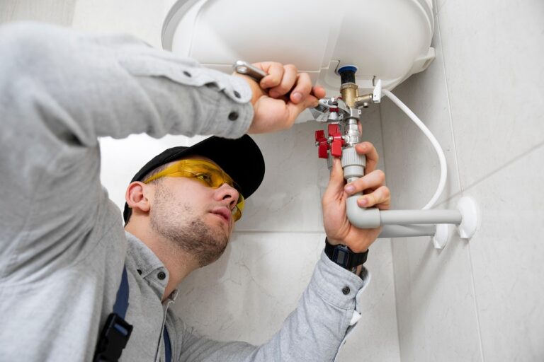 technician repairing a water heater
