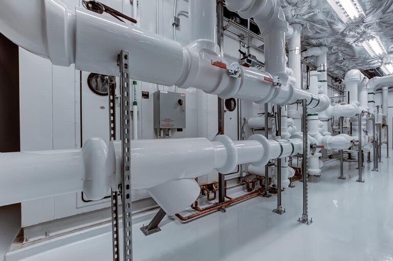 Commercial plumbing lines running across a room